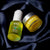 IncogniGlow Youth Burst Duo Serum on a satin black cloth 